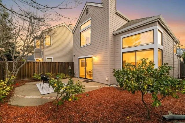 a view of a house with backyard and sitting area