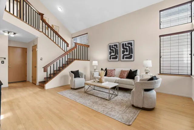 a living room with furniture and stairs