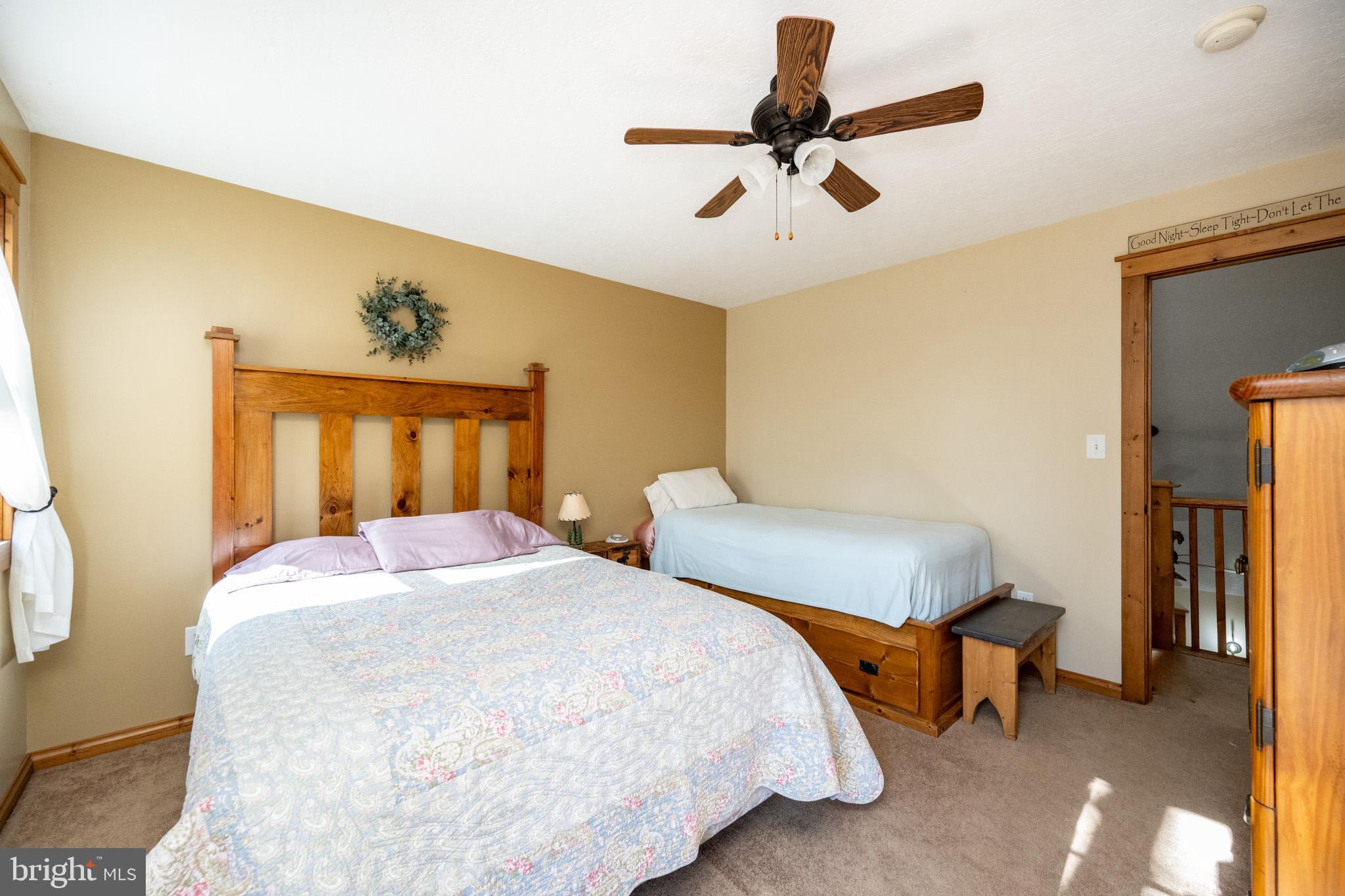328 Stool Rock Road Oakland, MD 21550 - Photo 67 of 133 a bedroom with a bed and a chandelier