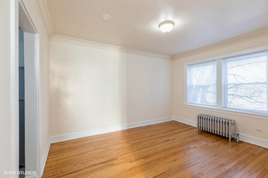 10981 South Church Street, Unit 3B Chicago, IL 60643 - Photo 5 of 8 a view of an empty room with wooden floor and a window