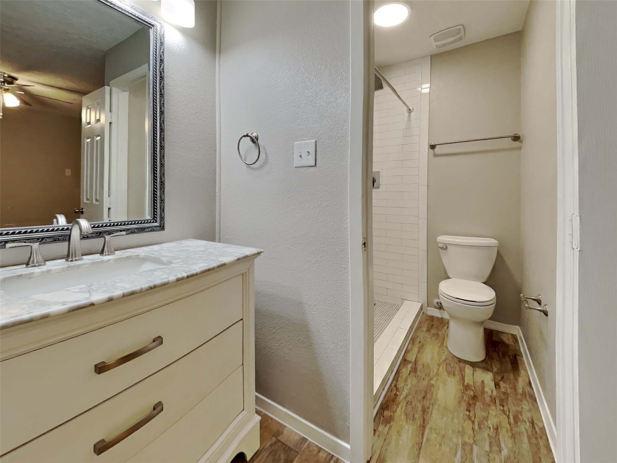 4315 Hirschfield Road Spring, TX 77373 - Photo 11 of 18 a bathroom with a granite countertop toilet a sink and a mirror