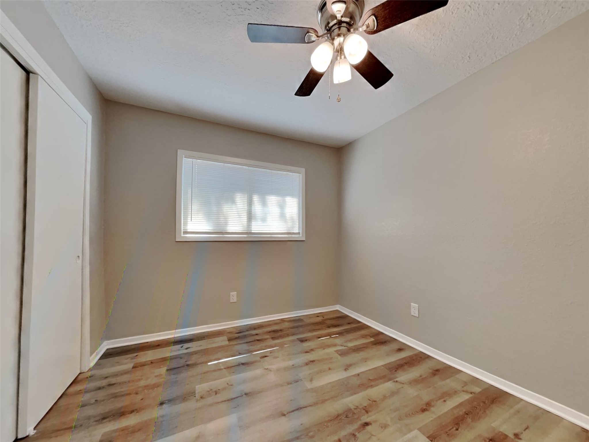 4315 Hirschfield Road Spring, TX 77373 - Photo 12 of 18 wooden floor in an empty room with a window