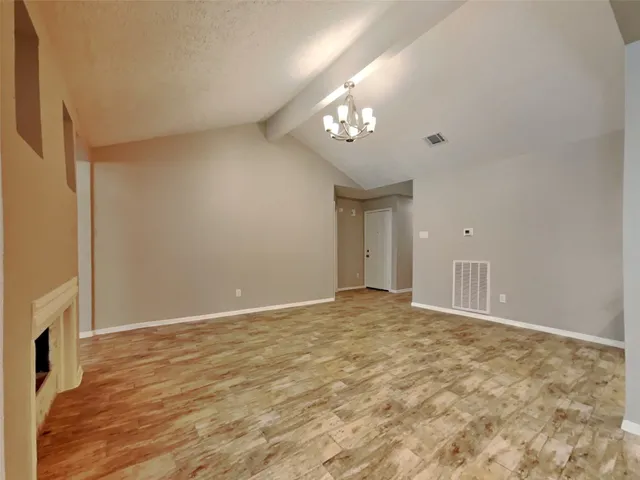 a view of an empty room with a fireplace