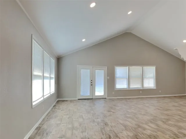 an empty room with windows and closet