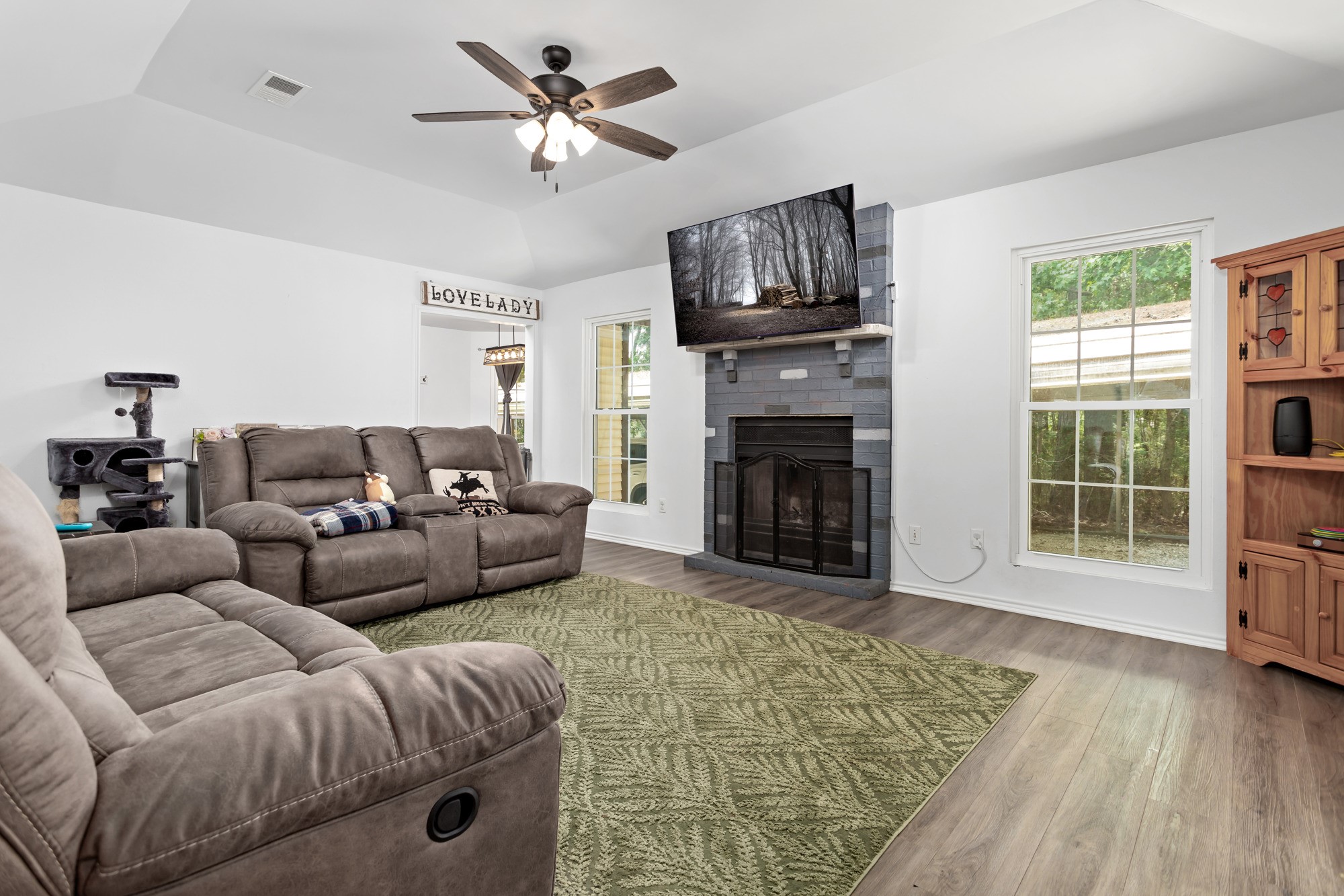 9994 Ruby Lane Silsbee, TX 77656 - Photo 3 of 17 a living room with furniture a flat screen tv and a fireplace