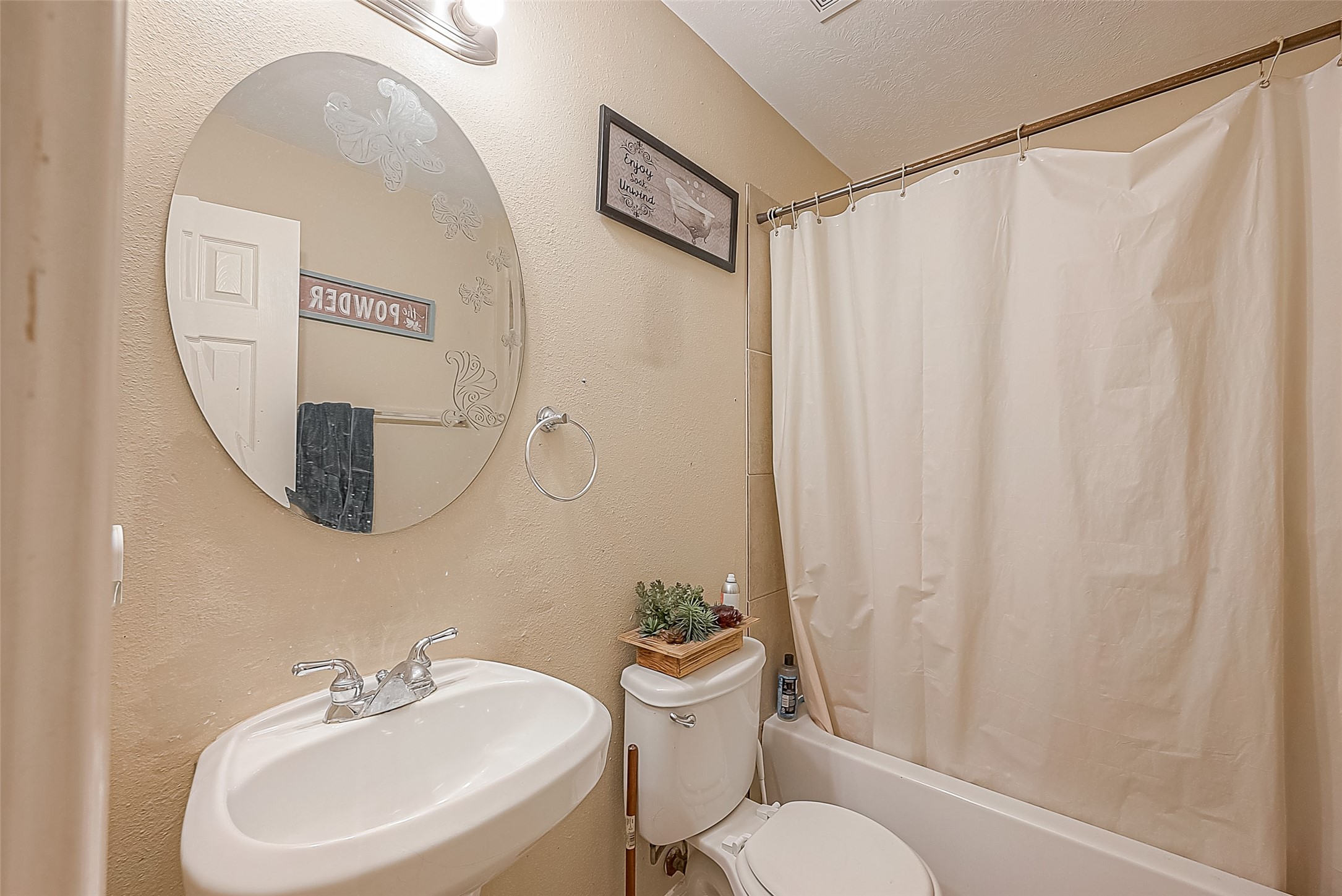 944 Dewalt Street Houston, TX 77088 - Photo 14 of 17 a bathroom with a sink mirror and a toilet