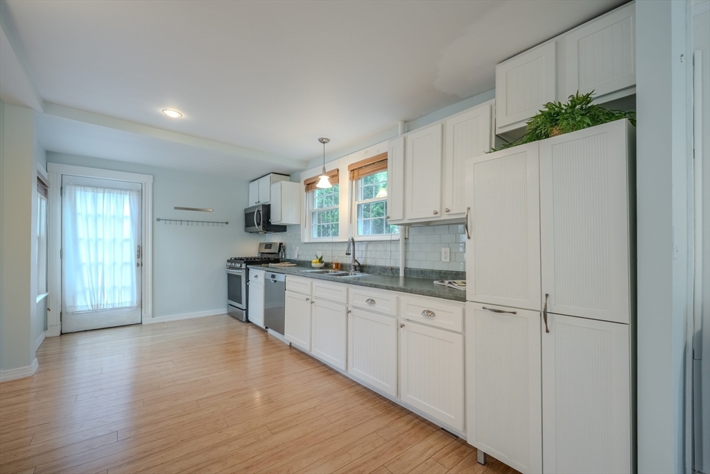 11 Lakeside Road Billerica, MA 01821 - Photo 13 of 38 a kitchen with granite countertop a refrigerator sink and cabinets