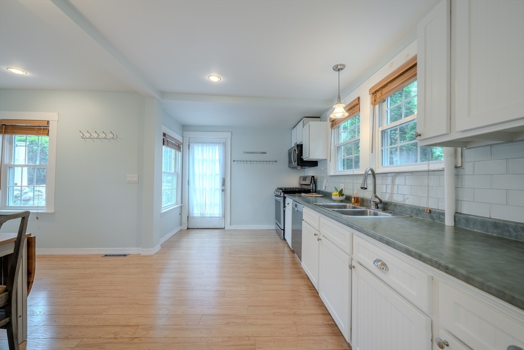 11 Lakeside Road Billerica, MA 01821 - Photo 14 of 38 a kitchen with granite countertop a sink a counter space appliances and cabinets