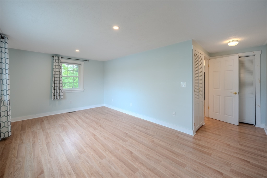 11 Lakeside Road Billerica, MA 01821 - Photo 19 of 38 an empty room with wooden floor and windows