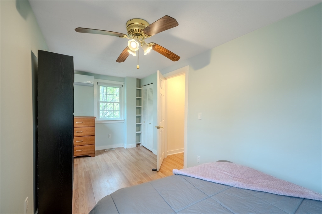 11 Lakeside Road Billerica, MA 01821 - Photo 21 of 38 a bedroom with a bed and wooden floor