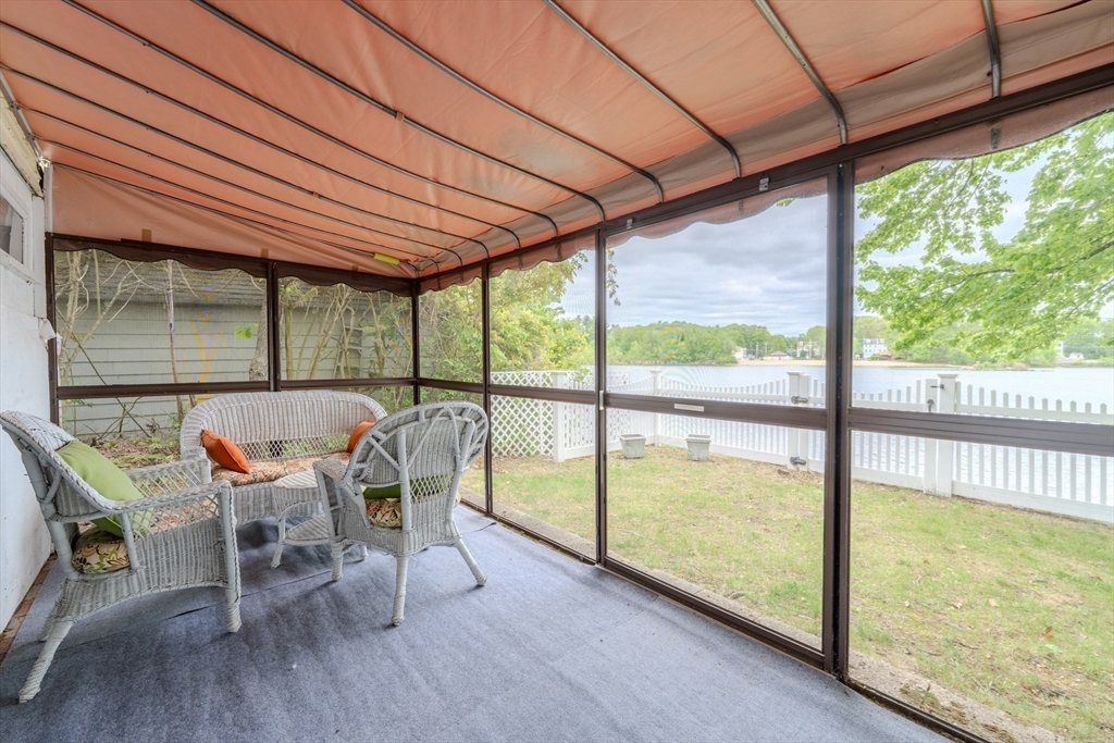 11 Lakeside Road Billerica, MA 01821 - Photo 25 of 38 a view of a patio with table and chairs under an umbrella