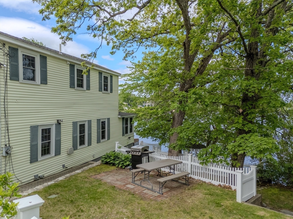 11 Lakeside Road Billerica, MA 01821 - Photo 27 of 38 a view of backyard with a table and chairs and a large tree