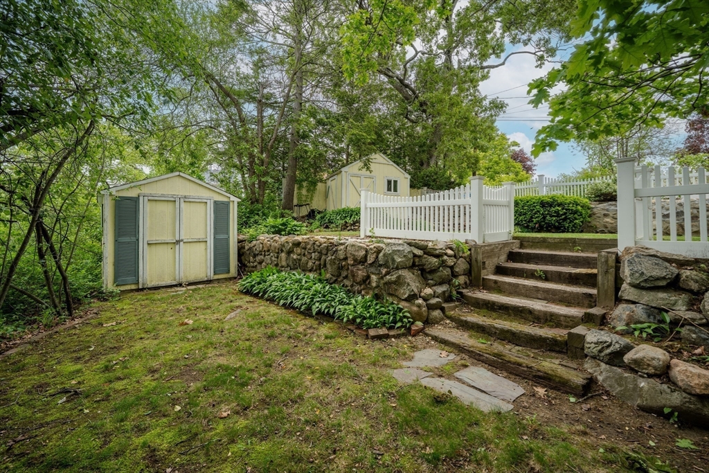 11 Lakeside Road Billerica, MA 01821 - Photo 28 of 38 a front view of a house with a garden and trees