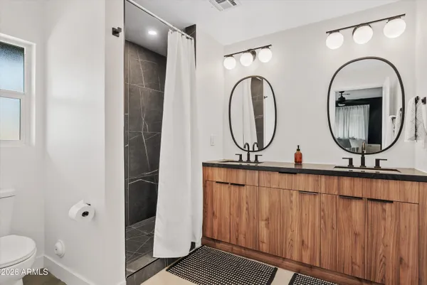 a bathroom with 2 sink and a mirror