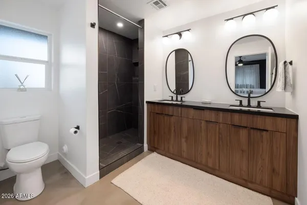 a bathroom with a toilet a sink and mirror