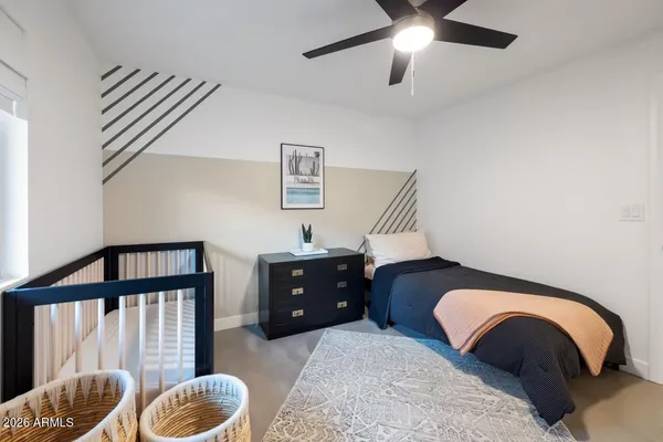 a bedroom with furniture and a window