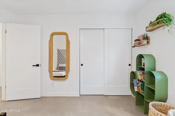 a bathroom with a granite countertop sink toilet a mirror and shower