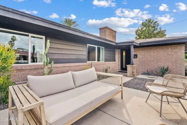 a view of swimming pool with a table and chair in patio