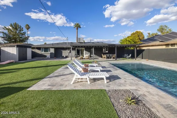 a view of swimming pool with outdoor seating