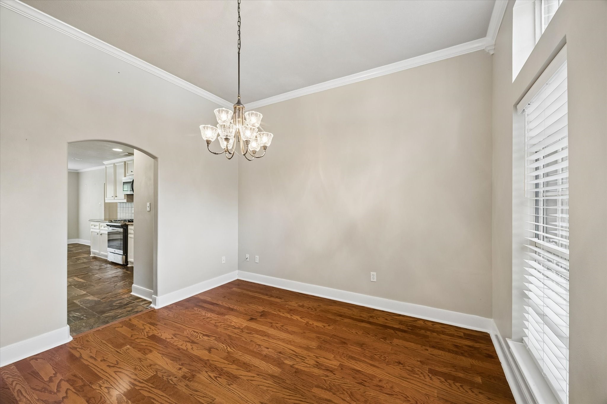 109 Dawns Edge Conroe, TX 77356 - Photo 10 of 24 a view of a room with a chandelier fan and wooden floor
