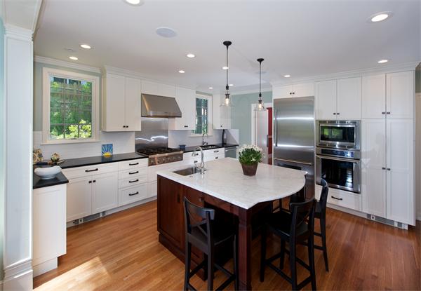 31 Sheffield Road Newton, MA 02460 - Photo 7 of 16 a kitchen with refrigerator cabinets dining table and chairs