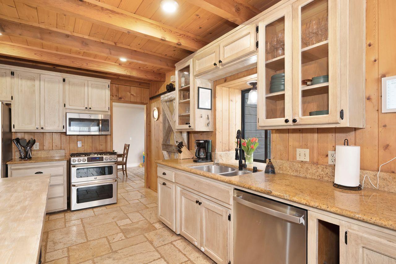 5501 Scott Road Sloughhouse, CA 95683 - Photo 18 of 87 a kitchen with stainless steel appliances granite countertop a stove a sink and a microwave