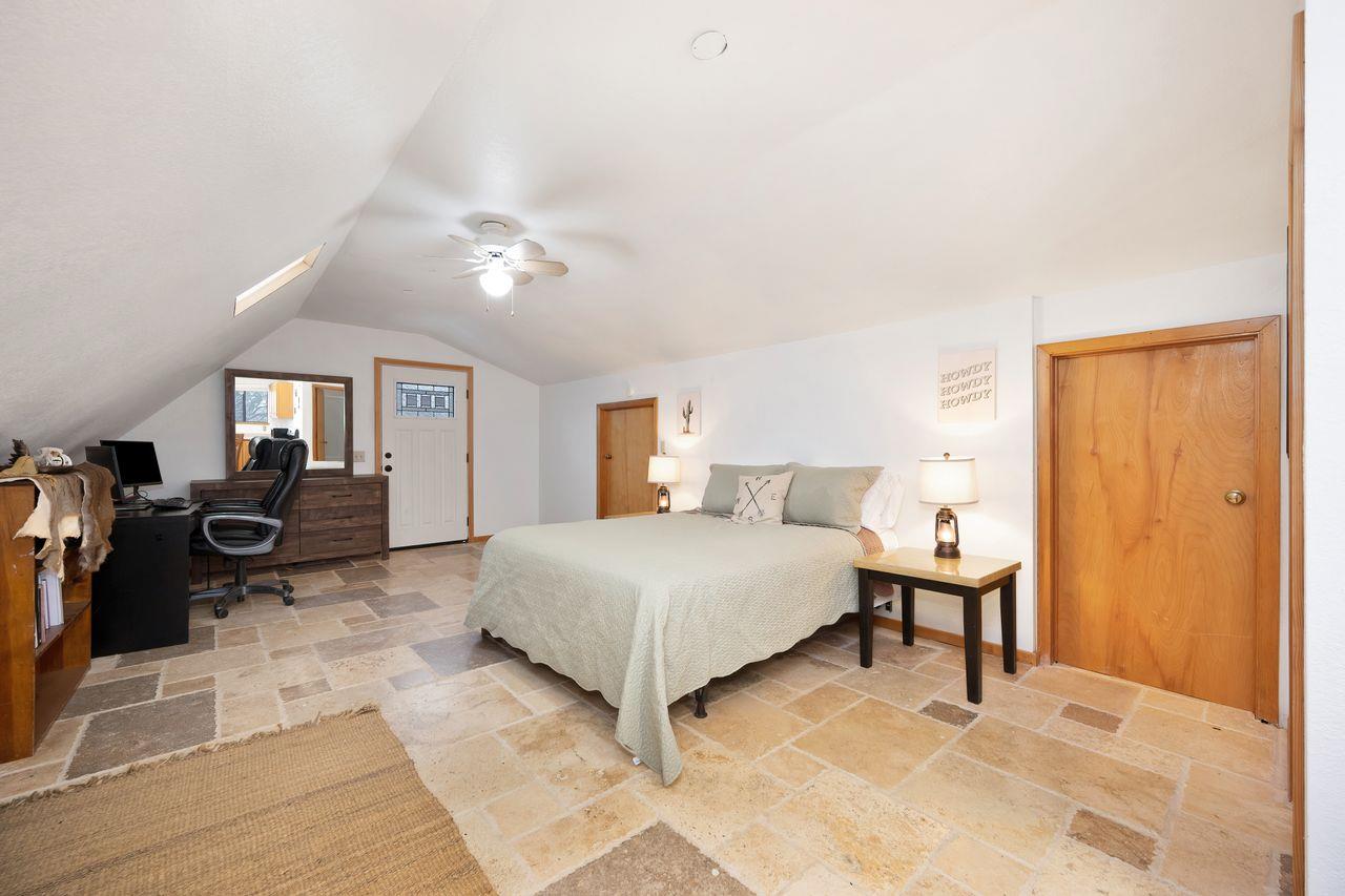 5501 Scott Road Sloughhouse, CA 95683 - Photo 63 of 87 a spacious bedroom with a bed and lamp chandelier