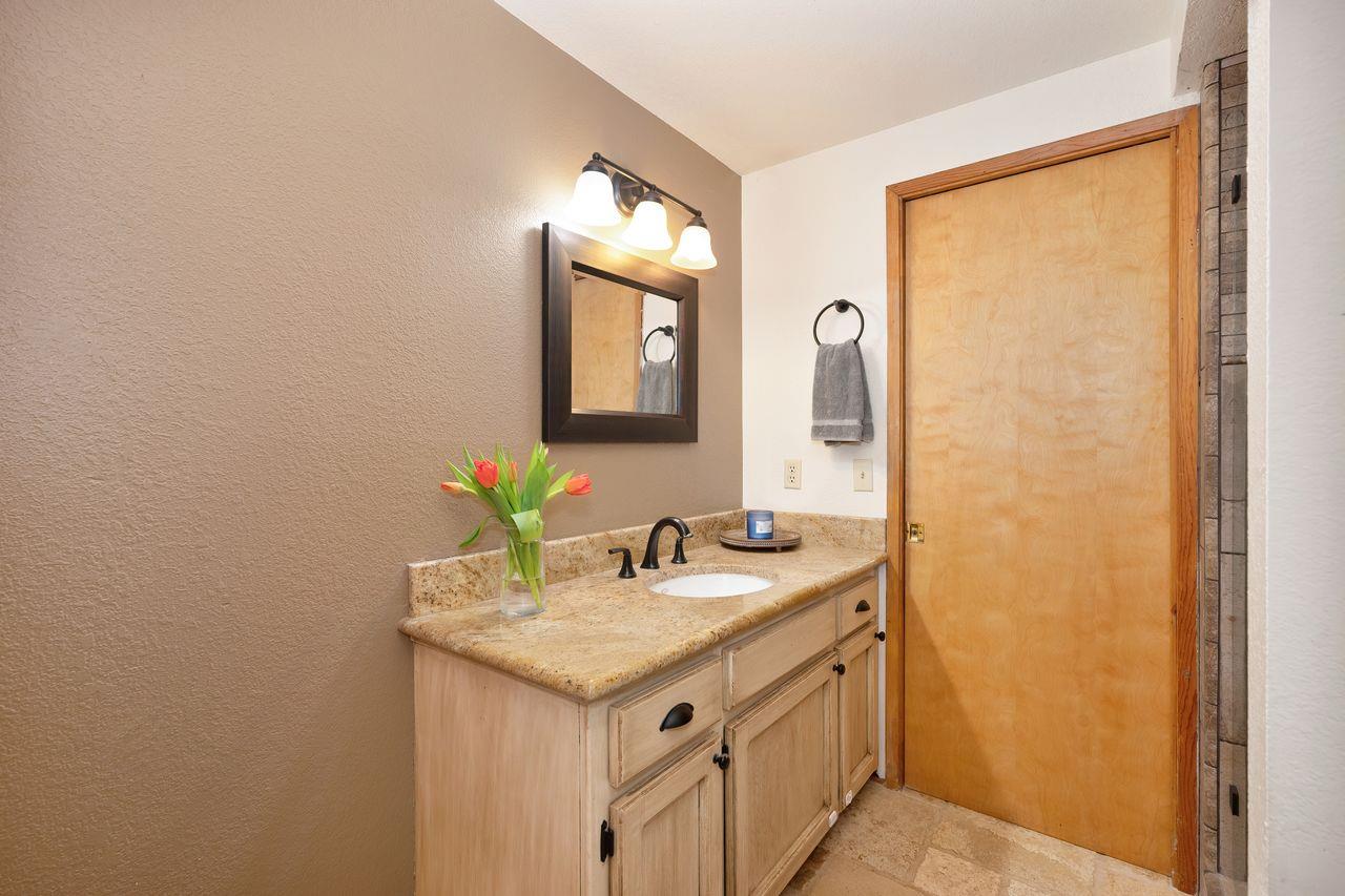 5501 Scott Road Sloughhouse, CA 95683 - Photo 7 of 87 a bathroom with a granite countertop sink and a mirror