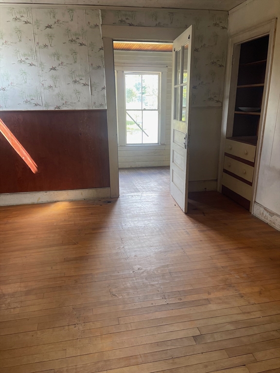 662 Main Street Ashby, MA 01431 - Photo 11 of 20 an empty room with wooden floor and windows