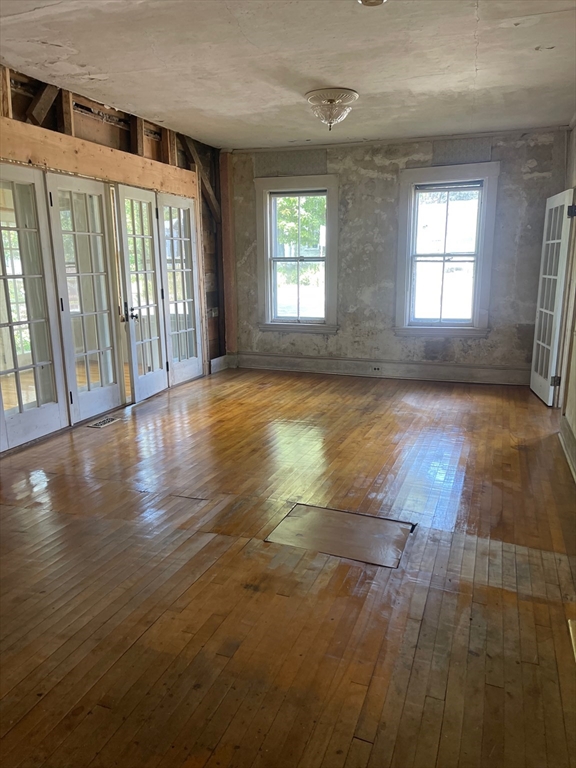 662 Main Street Ashby, MA 01431 - Photo 3 of 20 an empty room with wooden floor and windows