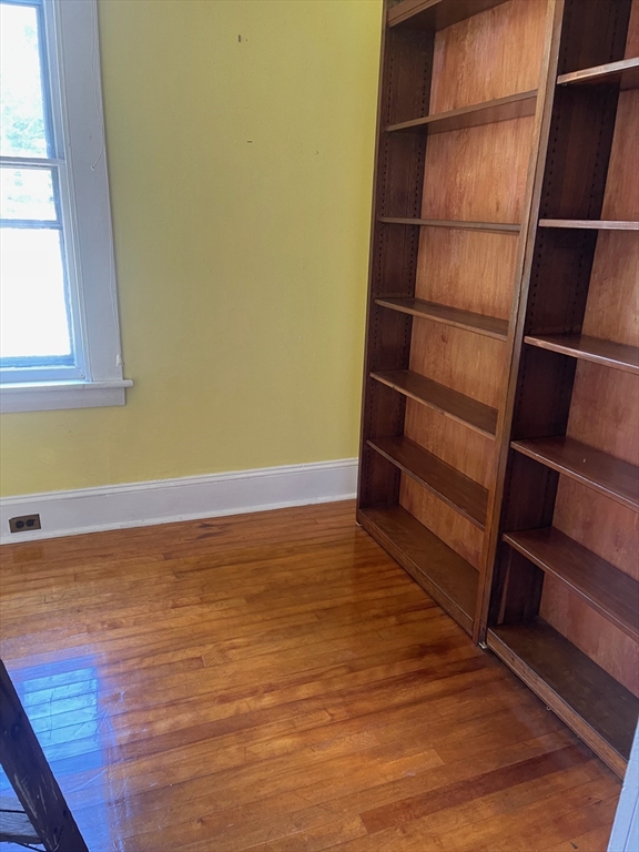 662 Main Street Ashby, MA 01431 - Photo 4 of 20 a view of an empty room with wooden floor and a window