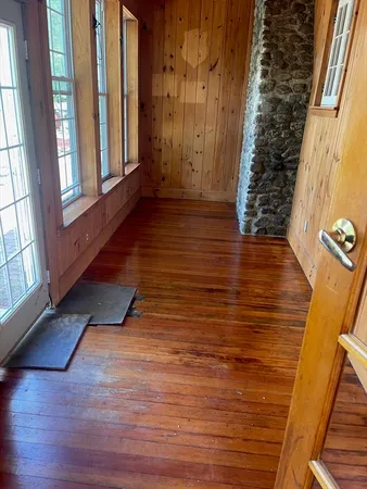 a view of front door with wooden floor