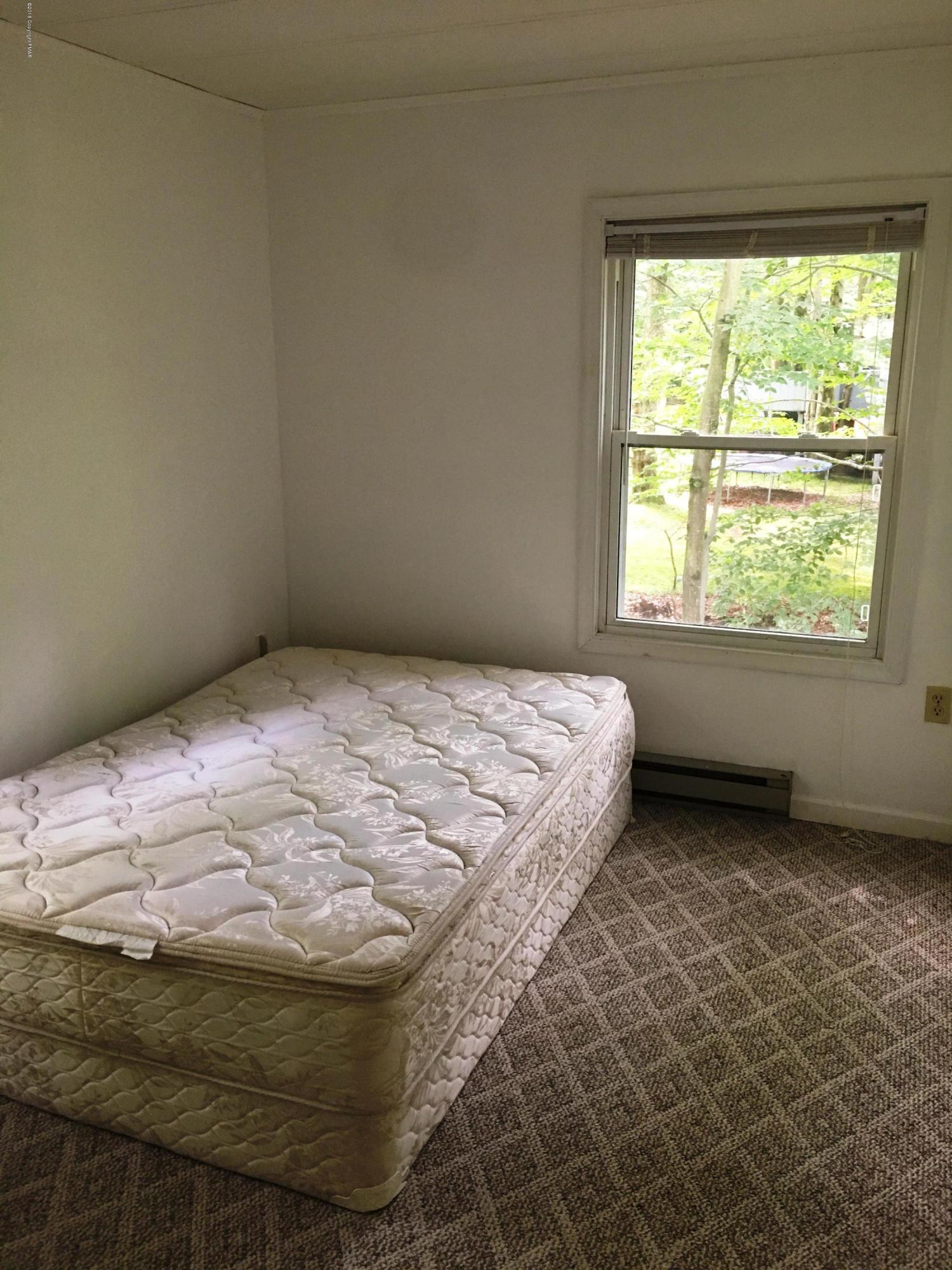 35 Kensington Road Hawley, PA 18428 - Photo 11 of 21 a bed sitting in a bedroom next to a window