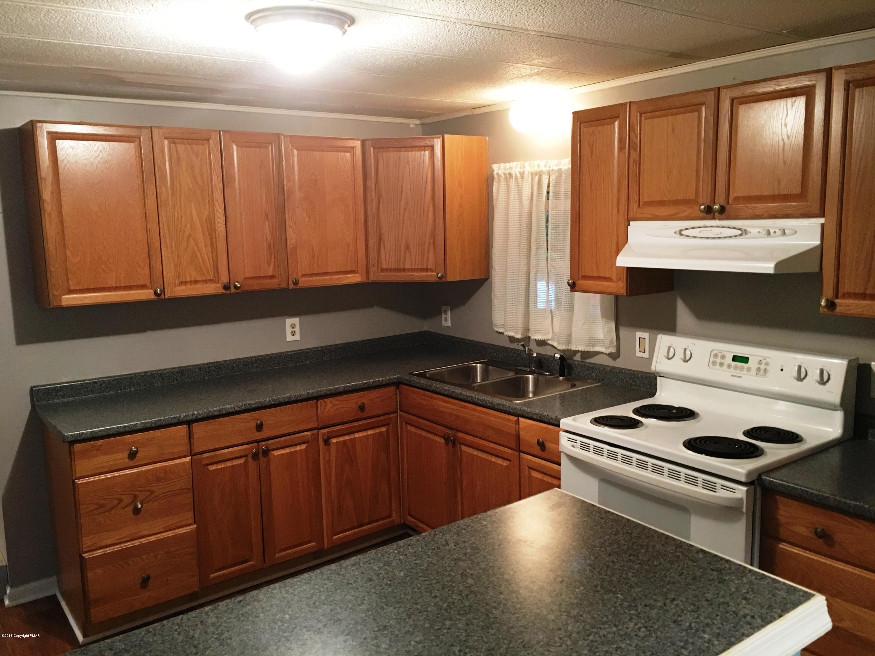 35 Kensington Road Hawley, PA 18428 - Photo 2 of 21 a kitchen with stainless steel appliances a stove sink and cabinets