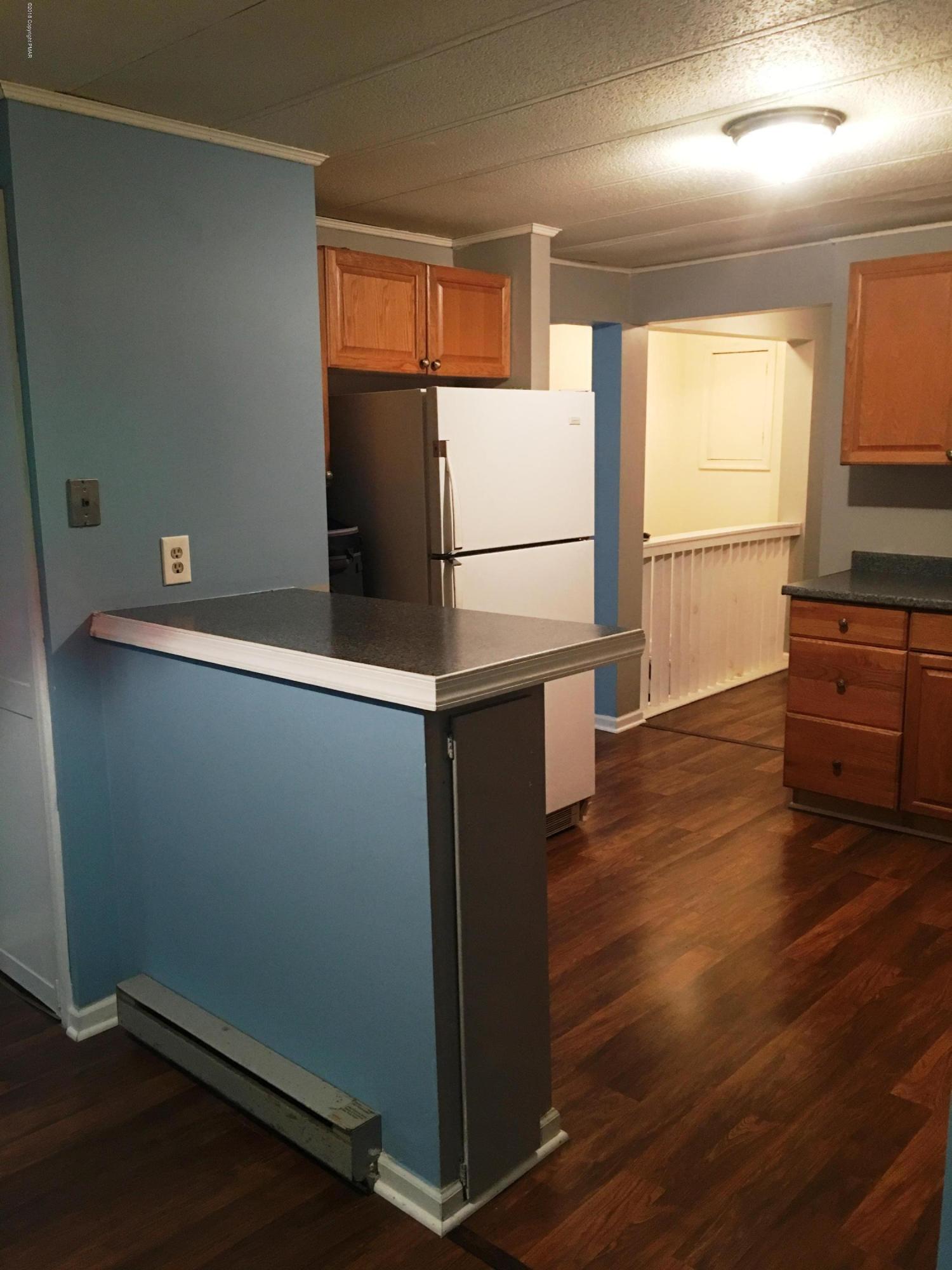 35 Kensington Road Hawley, PA 18428 - Photo 3 of 21 a kitchen with wooden floors and wide window