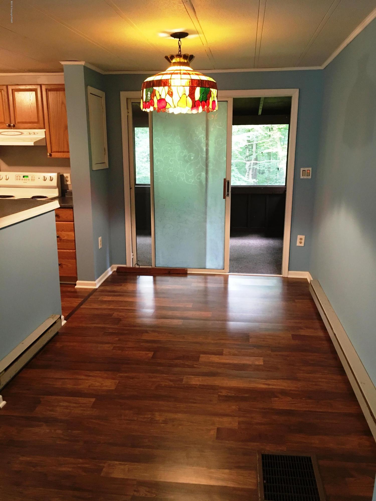 35 Kensington Road Hawley, PA 18428 - Photo 4 of 21 a view of kitchen with kitchen island wooden floor and window