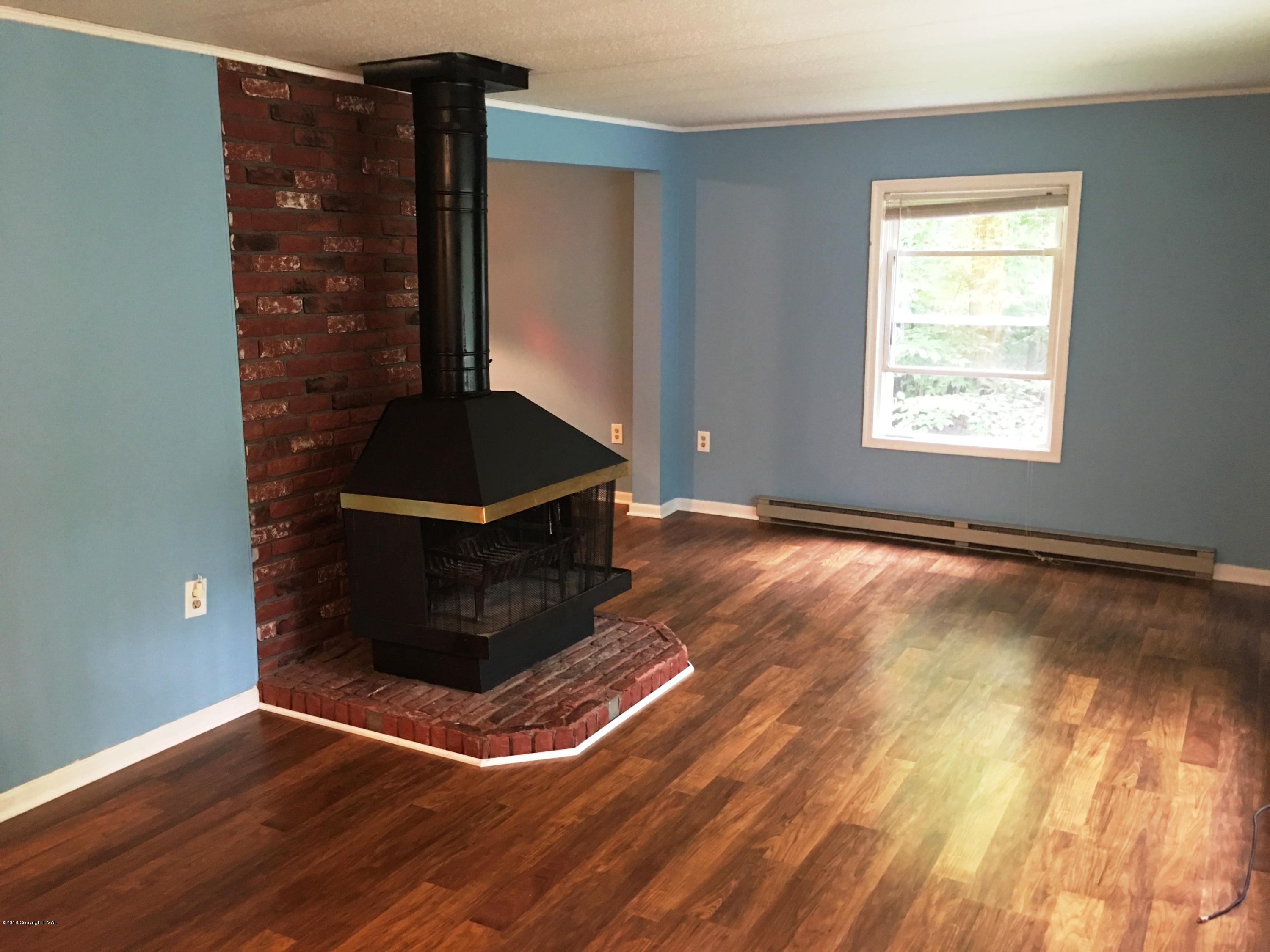 35 Kensington Road Hawley, PA 18428 - Photo 6 of 21 a living room with hard wood floors and a window