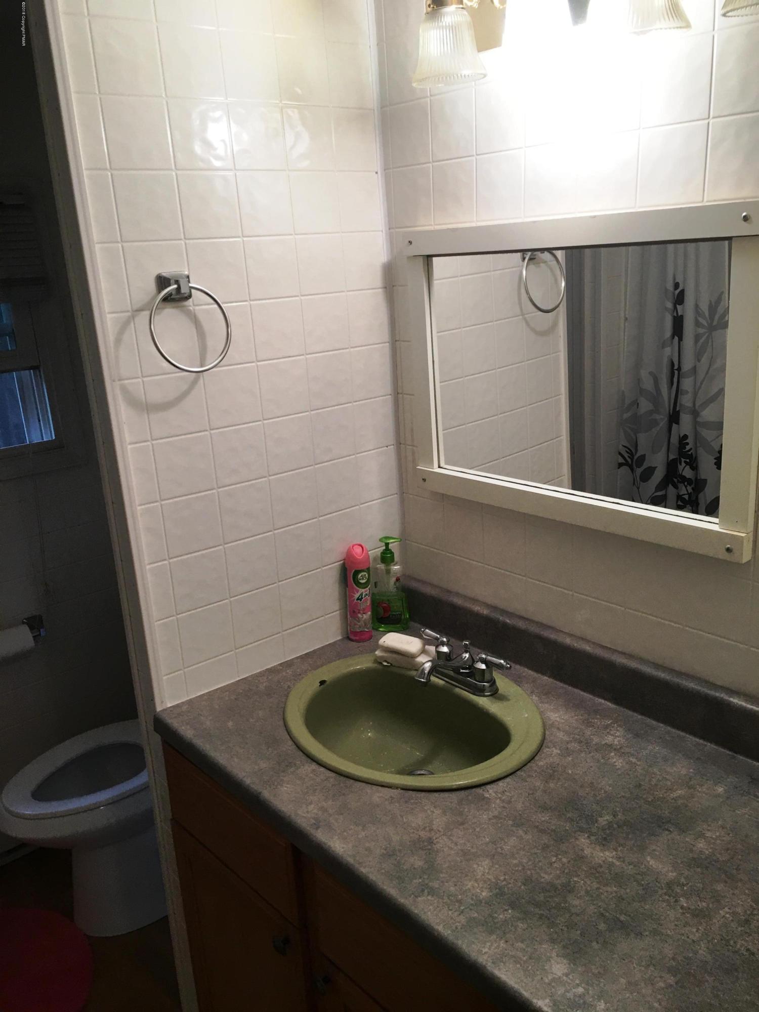 35 Kensington Road Hawley, PA 18428 - Photo 9 of 21 a bathroom with a sink a toilet a mirror and shower