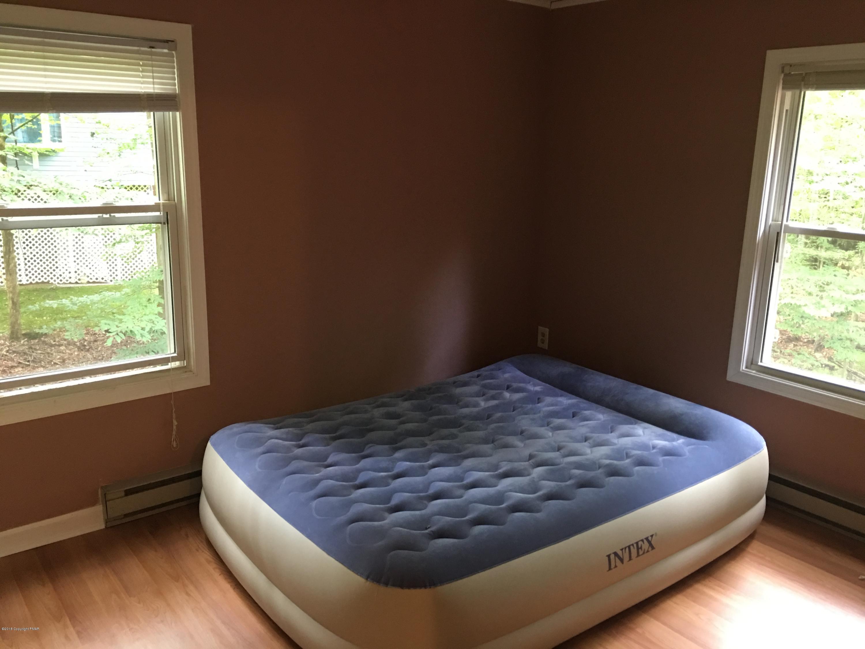 35 Kensington Road Hawley, PA 18428 - Photo 10 of 21 a bed sitting in a bedroom next to a window