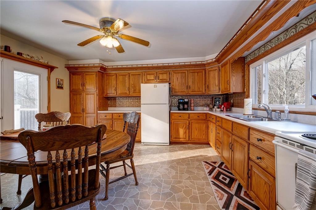 4249 Hollow Road New Castle, PA 16101 - Photo 12 of 33 a kitchen with a refrigerator a stove a sink and dishwasher with a dining table