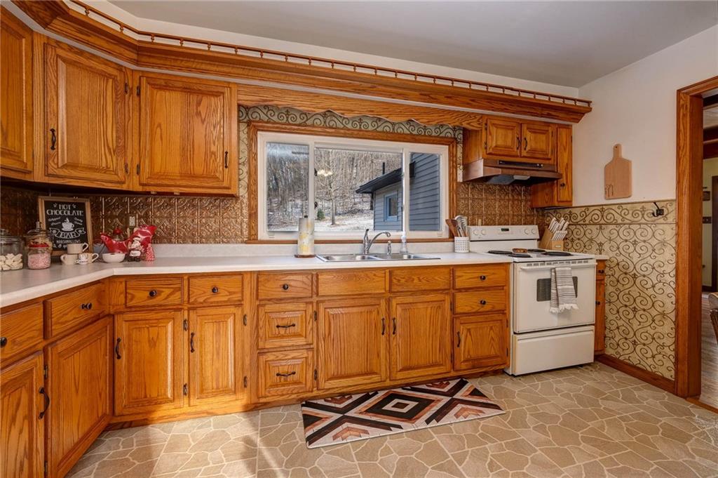 4249 Hollow Road New Castle, PA 16101 - Photo 14 of 33 a kitchen with stainless steel appliances granite countertop a sink and cabinets