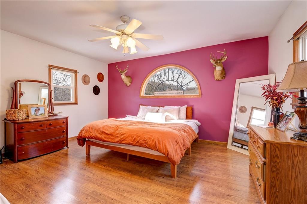 4249 Hollow Road New Castle, PA 16101 - Photo 15 of 33 a bedroom with a bed and a chandelier