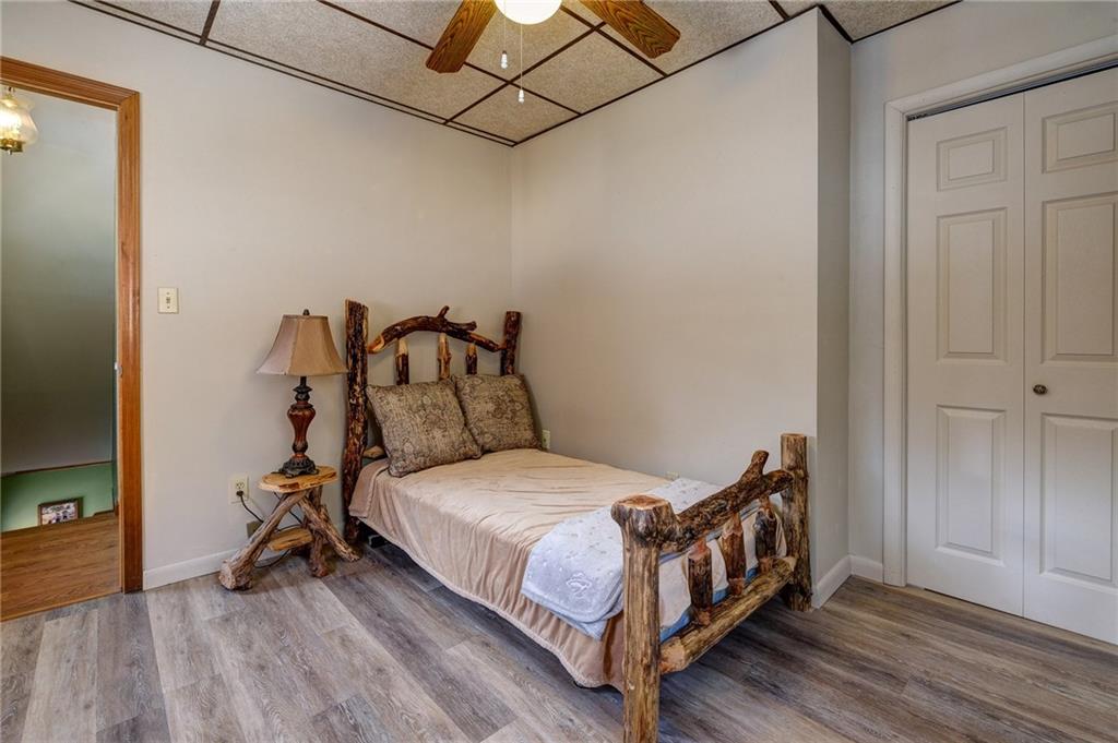 4249 Hollow Road New Castle, PA 16101 - Photo 21 of 33 a bedroom with a bed and a wooden floor