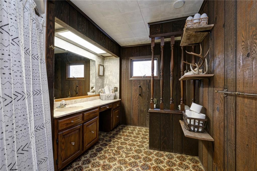4249 Hollow Road New Castle, PA 16101 - Photo 23 of 33 a bathroom with a sink a mirror and a shower