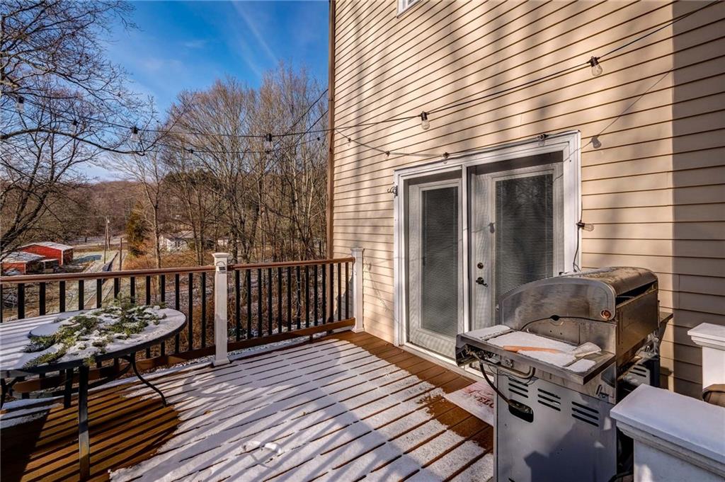 4249 Hollow Road New Castle, PA 16101 - Photo 25 of 33 a roof deck with a dining table and chairs with wooden floor