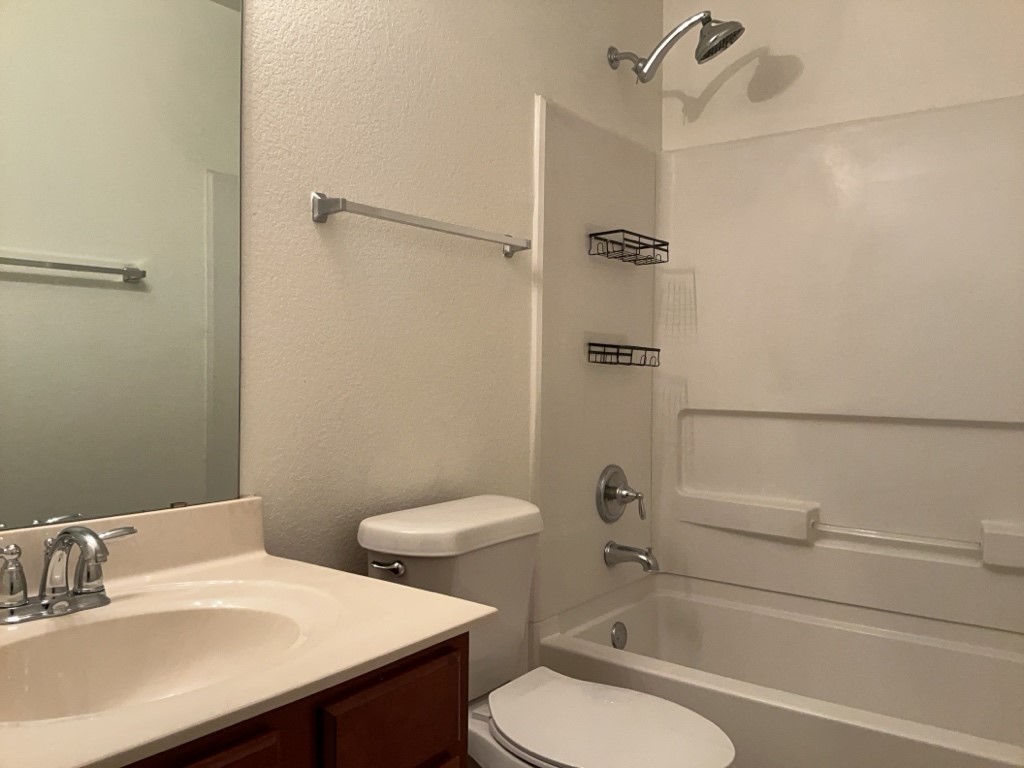 2242 Perkins Place Georgetown, TX 78626 - Photo 19 of 25 Bathroom featuring a single vanity, integrated sink, chrome faucet, and a wall-mounted mirror
