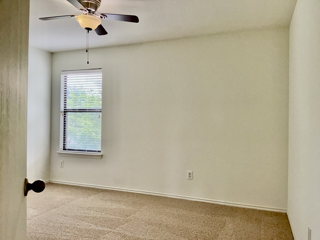 2242 Perkins Place Georgetown, TX 78626 - Photo 20 of 25 Interior room featuring neutral wall tones and textured carpet flooring