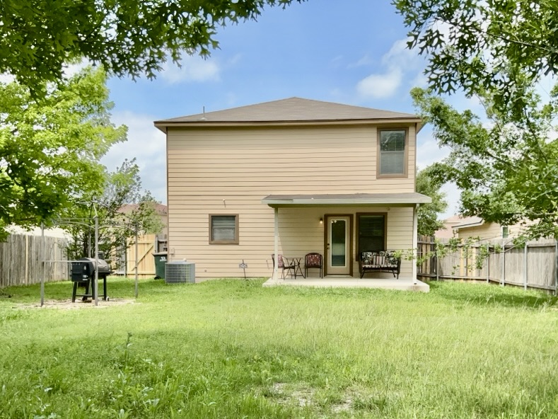 2242 Perkins Place Georgetown, TX 78626 - Photo 25 of 25 Rear elevation featuring tan siding and a brown shingle roof