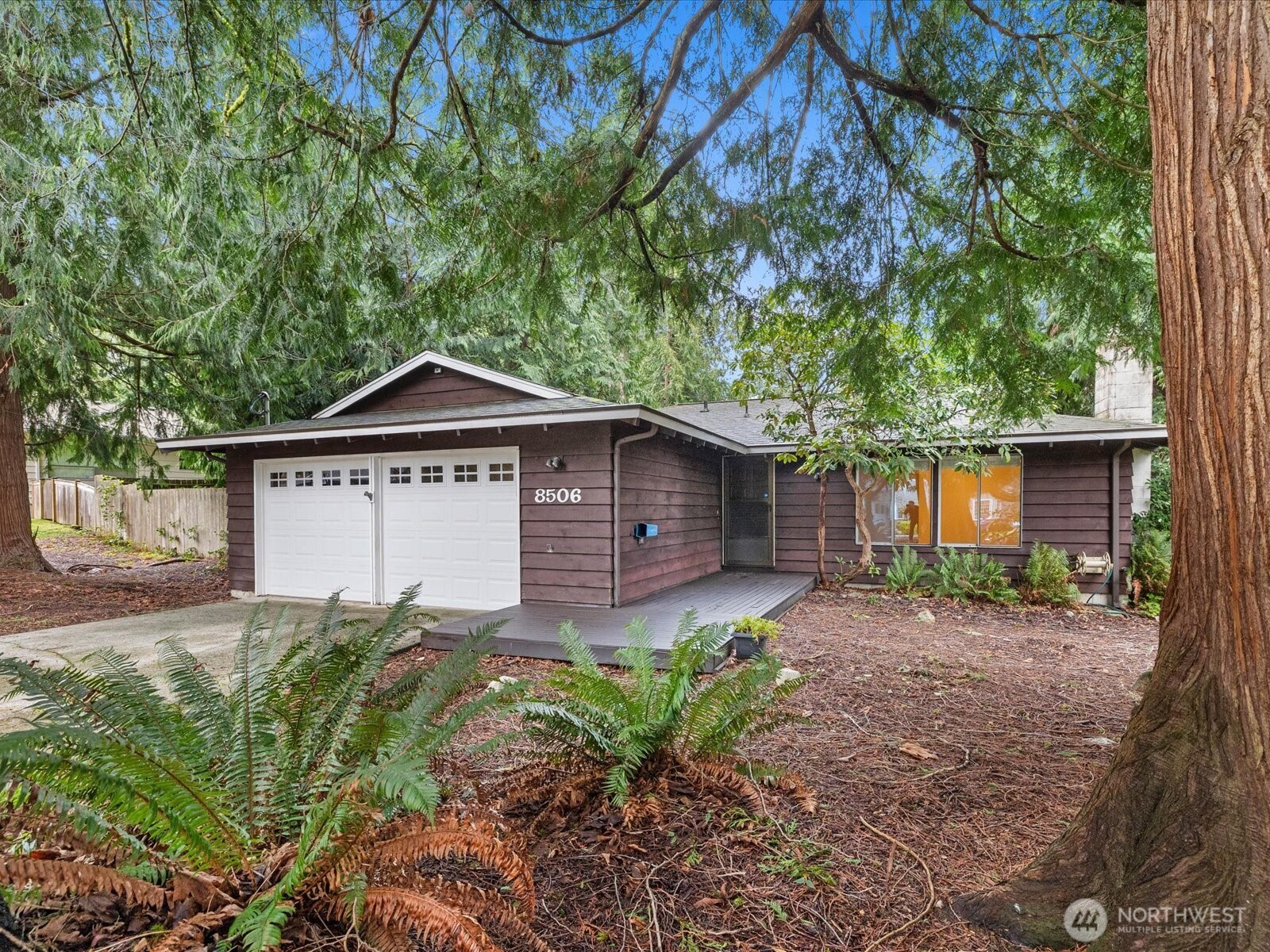 8506 192nd Street Southwest Edmonds, WA 98026 - Photo 1 of 37 a small house with a big yard and large trees