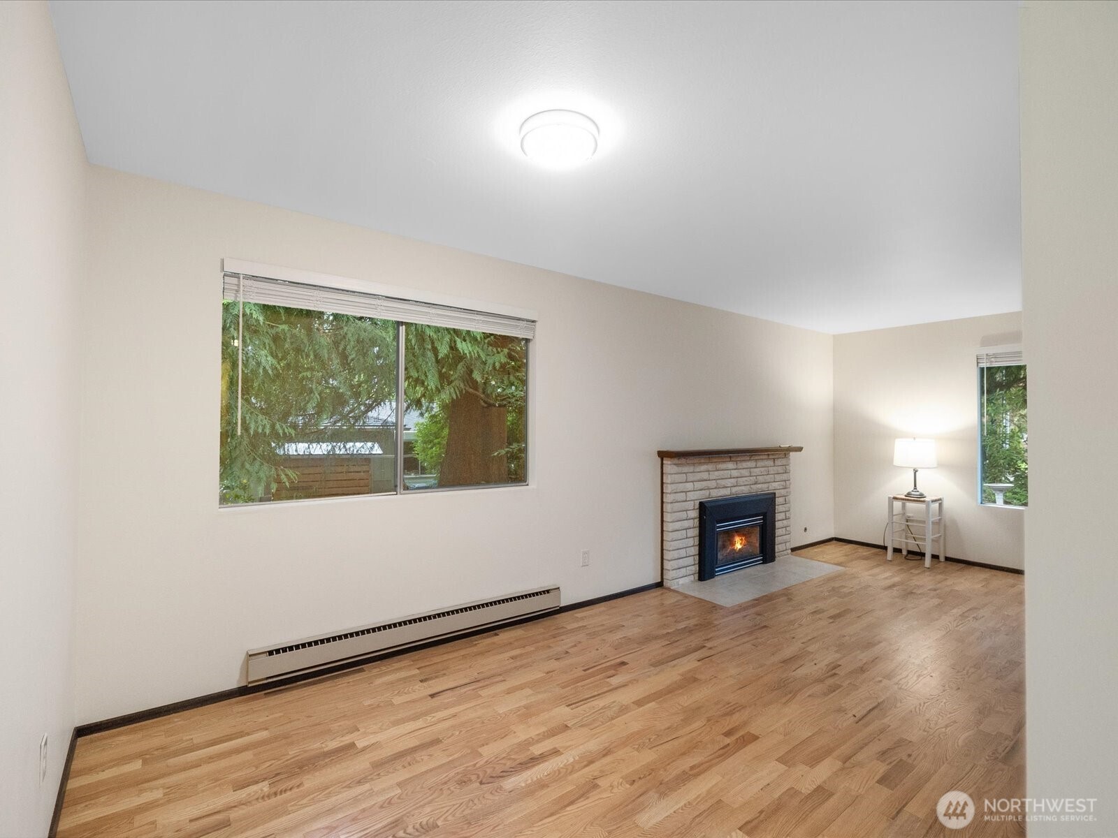 8506 192nd Street Southwest Edmonds, WA 98026 - Photo 11 of 37 an empty room with fireplace and windows